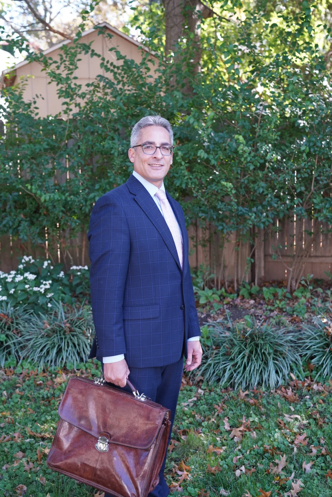 David S. Mildenberg standing outdoors in a navy suit.